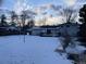 Large backyard with snow covered lawn, providing a serene view of the home at 3062 S Florence Ct, Denver, CO 80231