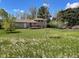 Expansive backyard with lush green lawn and a spacious wooden deck at 3062 S Florence Ct, Denver, CO 80231