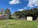 Large backyard featuring mature trees, storage shed, and lush green grass at 3062 S Florence Ct, Denver, CO 80231