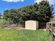Backyard shed with a well-maintained fence, mature trees, and a green lawn at 3062 S Florence Ct, Denver, CO 80231