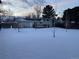 View of the backyard featuring a wood deck covered in fresh snow on a cold winter's day at 3062 S Florence Ct, Denver, CO 80231