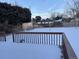 Deck overlooking spacious backyard, partially covered in snow at 3062 S Florence Ct, Denver, CO 80231
