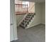 Finished basement with carpeted floors and staircase at 3062 S Florence Ct, Denver, CO 80231