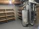 Unfinished basement with shelving, water heater, and HVAC system at 3062 S Florence Ct, Denver, CO 80231