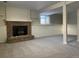 Finished basement with fireplace and carpeted floors at 3062 S Florence Ct, Denver, CO 80231