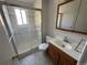 Updated bathroom with a shower and wood vanity at 3062 S Florence Ct, Denver, CO 80231