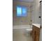 Bathroom with tile flooring, tub, and wood vanity at 3062 S Florence Ct, Denver, CO 80231