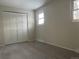 Well-lit bedroom featuring grey carpet and double door closet at 3062 S Florence Ct, Denver, CO 80231
