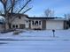 Ranch style home with attached garage and mature landscaping at 3062 S Florence Ct, Denver, CO 80231