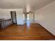 Hardwood floor living room with access to kitchen and dining area at 3062 S Florence Ct, Denver, CO 80231
