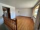 Spacious living room with hardwood floors, view into kitchen and access to upper level at 3062 S Florence Ct, Denver, CO 80231