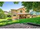 Well-maintained backyard features a covered patio, lush lawn and mature trees, perfect for outdoor living at 19815 E Progress Ln, Centennial, CO 80015