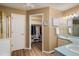 Well-lit bathroom offering access to a walk-in closet and vanity with sink at 19815 E Progress Ln, Centennial, CO 80015