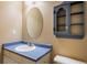 Well-lit bathroom with vintage cabinet, light color walls, and updated fixtures at 19815 E Progress Ln, Centennial, CO 80015