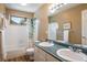 Bright bathroom featuring double sinks, ample counter space, and a shower-tub combo at 19815 E Progress Ln, Centennial, CO 80015