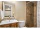 Updated bathroom features a modern vanity and a tiled walk-in shower with a shower curtain at 19815 E Progress Ln, Centennial, CO 80015