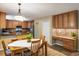 Cozy dining room adjacent to kitchen features wooden table, stylish lighting, and built in desk at 19815 E Progress Ln, Centennial, CO 80015