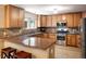 Well-appointed kitchen features granite countertops, stainless steel appliances, and custom wood cabinetry at 19815 E Progress Ln, Centennial, CO 80015