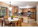 Bright eat-in kitchen features stainless steel appliances, wood cabinetry, granite countertops, and ample storage at 19815 E Progress Ln, Centennial, CO 80015
