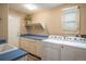 Well-equipped laundry room with washer, dryer, ample storage, and a convenient sink at 19815 E Progress Ln, Centennial, CO 80015