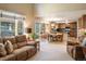 Inviting living room featuring neutral tones, access to a dining area, and seamless indoor-outdoor flow at 19815 E Progress Ln, Centennial, CO 80015