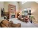 Spacious living room with fireplace, built-in bookshelves, and large windows for natural light at 19815 E Progress Ln, Centennial, CO 80015