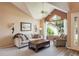 Comfortable living room features vaulted ceiling, ample natural light, and neutral decor at 19815 E Progress Ln, Centennial, CO 80015