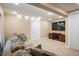 Living room with neutral walls and carpet features a sofa, television, and entertainment center at 19815 E Progress Ln, Centennial, CO 80015