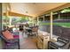 Spacious covered patio with multiple seating areas, outdoor grill, and a wood-burning fire pit at 19815 E Progress Ln, Centennial, CO 80015