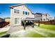 Backyard featuring a concrete patio with a gazebo and an artificial grass lawn at 7150 E 121St Pl, Thornton, CO 80602