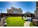 Backyard featuring artificial turf, a stone retaining wall and a gazebo at 7150 E 121St Pl, Thornton, CO 80602