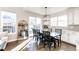Bright dining room featuring dark wood table, chairs, and hardwood floors with access to the kitchen and backyard at 7150 E 121St Pl, Thornton, CO 80602