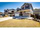 Beautifully designed two-story house with a covered front porch, two-car garage, and manicured lawn at 7150 E 121St Pl, Thornton, CO 80602