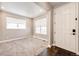 Bright foyer with neutral walls, carpeted floors, and natural light streaming through the front windows at 7150 E 121St Pl, Thornton, CO 80602