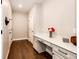 Bright hallway with a built-in desk, drawers, and neutral walls, complemented by hardwood flooring at 7150 E 121St Pl, Thornton, CO 80602