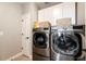 Laundry room with newer appliances, storage cabinets, and access to a door at 7150 E 121St Pl, Thornton, CO 80602
