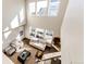 Aerial view of the living room featuring high ceilings, natural light, and contemporary furnishings at 7150 E 121St Pl, Thornton, CO 80602