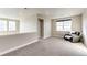 Upstairs loft area with neutral walls, carpet, and a comfortable armchair, offering a cozy retreat at 7150 E 121St Pl, Thornton, CO 80602