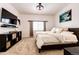 Bedroom with a TV, storage, and a large window that offers ample natural light at 9381 Ashbury Cir # 102, Parker, CO 80134