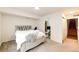 Cozy bedroom with neutral walls, neutral carpet, comfortable bed, and an ensuite bathroom at 9381 Ashbury Cir # 102, Parker, CO 80134