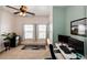 Cozy bedroom with carpet, and an accent wall creating a dedicated office space with dual monitors at 9381 Ashbury Cir # 102, Parker, CO 80134