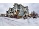 Gray three-story townhome with attached garage at 9381 Ashbury Cir # 102, Parker, CO 80134