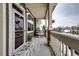Small front porch with seating area, covered and with snowy ground at 9381 Ashbury Cir # 102, Parker, CO 80134