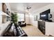 Open living room with fireplace, leather furniture, and large TV at 9381 Ashbury Cir # 102, Parker, CO 80134