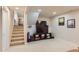 Finished basement with entertainment center and stairs to main floor at 6472 W Brittany Pl, Littleton, CO 80123