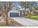 Charming home exterior with a well-manicured lawn, a gray garage door, and a paved driveway at 6472 W Brittany Pl, Littleton, CO 80123