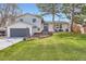 Charming two-story home with well-manicured lawn, gray trim, and attached garage at 6472 W Brittany Pl, Littleton, CO 80123