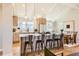 Bright, modern kitchen with stainless steel appliances, island, and open to the dining area at 6472 W Brittany Pl, Littleton, CO 80123