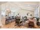 Inviting living room and kitchen area with vaulted ceiling, wood floors, and modern decor at 6472 W Brittany Pl, Littleton, CO 80123