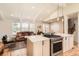 Open concept kitchen and living room with a view of the stairwell and front entry at 6472 W Brittany Pl, Littleton, CO 80123